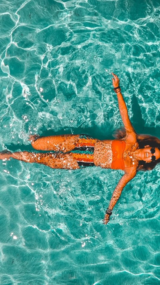 woman swimming alone in body of water